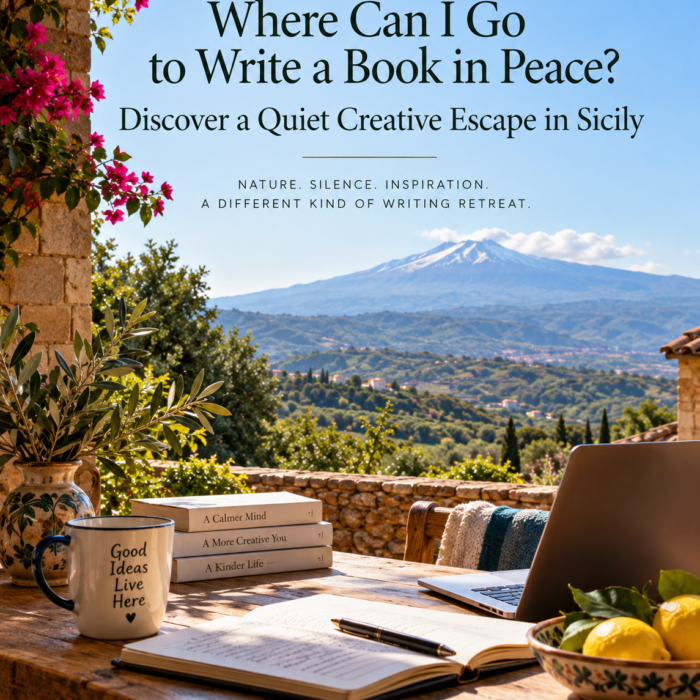 Writer's laptop and notebook on a peaceful Sicilian terrace overlooking the Alcantara Valley and Mount Etna, at a quiet creative escape in Sicily.