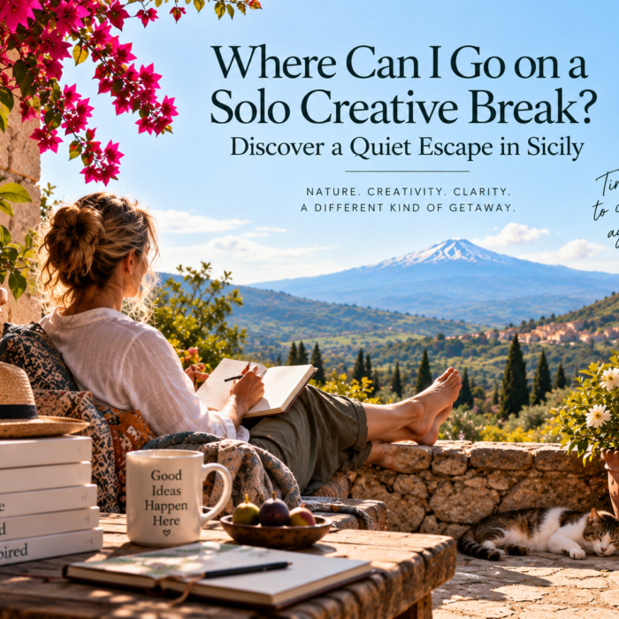 Woman enjoying a solo creative break in Sicily, writing in a journal on a peaceful terrace overlooking the Alcantara Valley and Mount Etna.
